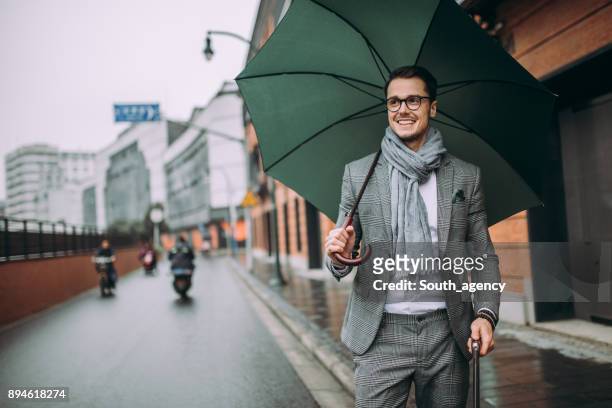 business traveler - rain model stock pictures, royalty-free photos & images