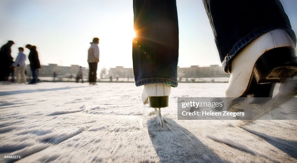 Ice skating with speed towards sun in Holland