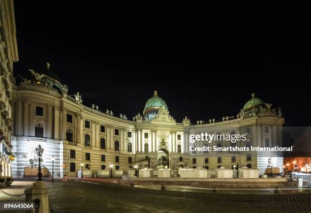 hofburg palace and michaelerplatz illuminated at night with no people in vienna, austria, a unesco heritage site - alte burg stock pictures, royalty-free photos & images