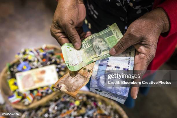 a vendor counts out rand banknotes - coin photos stock-fotos und bilder
