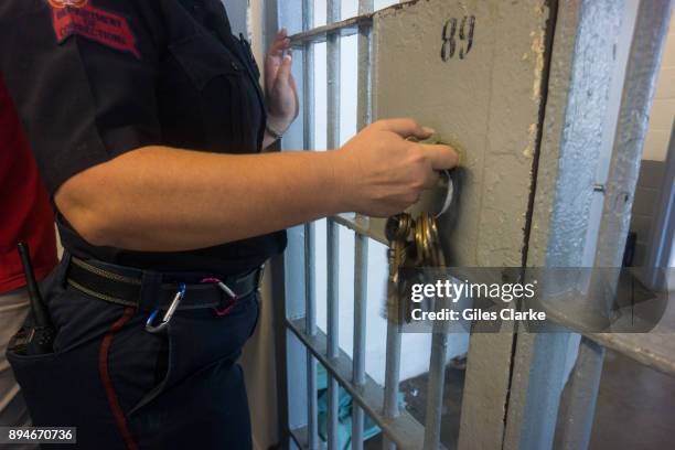 Prison guard opens a locked door with keys inside Angola prison. The Louisiana State Penitentiary, also known as Angola, and nicknamed the "Alcatraz...