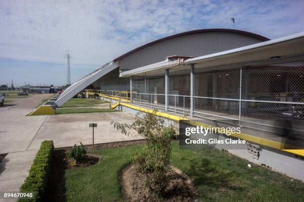 Angola prison buildings. The Louisiana State Penitentiary, also known as Angola, and nicknamed the "Alcatraz of the South" and "The Farm" is a...