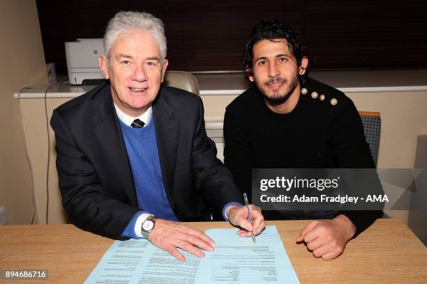 John Williams Chairman of West Bromwich Albion puts pen to paper as Ahmed Hegazi of West Bromwich Albion signs his contract to make his loan move...