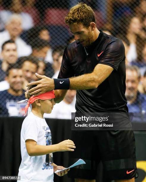 Juan Martin Del Potro talks with a child during an exhibition match between Juan Martin Del Potro and Nick Kyrgios at Luna Park on December 15, 2017...