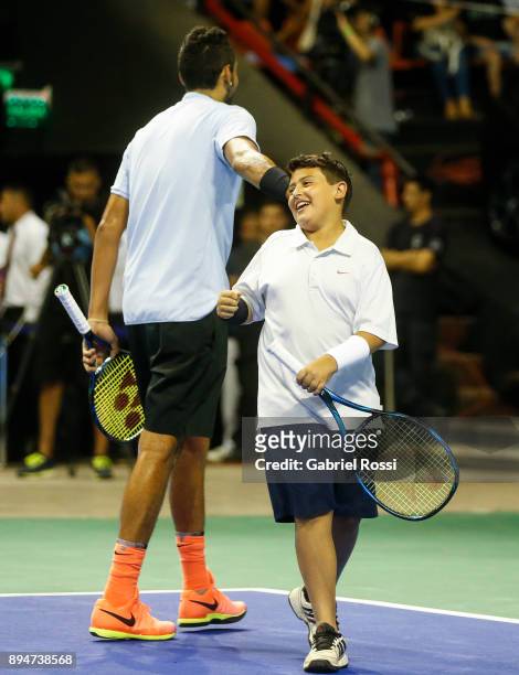 Nick Kyrgios of Australia greets a child during an exhibition match between Juan Martin Del Potro and Nick Kyrgios at Luna Park on December 15, 2017...
