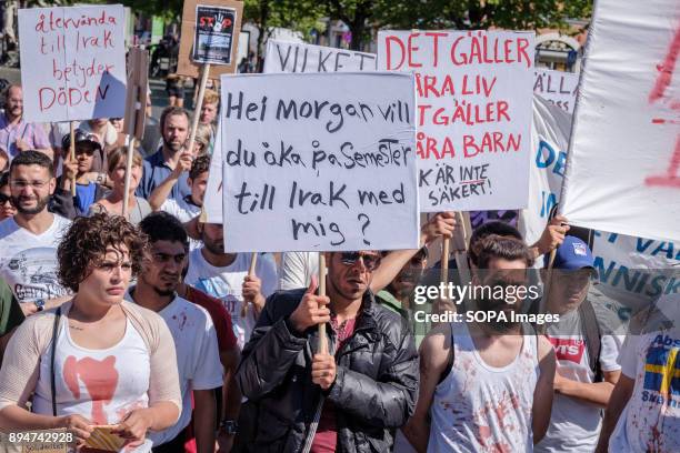 Several protesters seen attending the demonstration against migrants deportation while holding placards. As in many other Swedish cities, people...