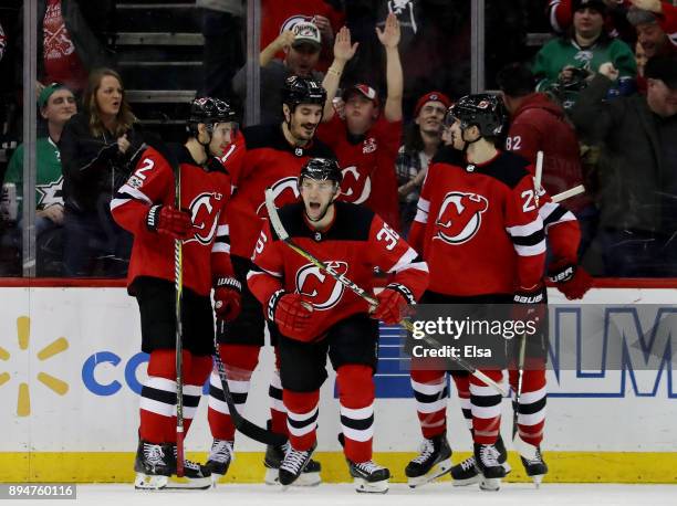 Nick Lappin of the New Jersey Devils celebrates his goal with teammates John Moore,Brian Boyle,Jimmy Hayes and Damon Severson in the third period...