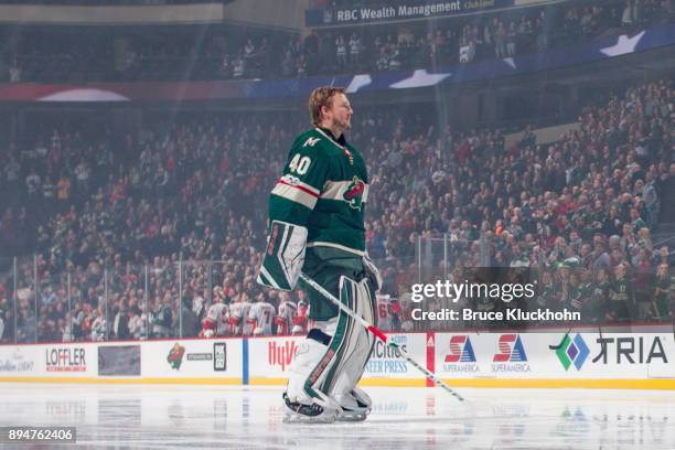 Devan Dubnyk of the Minnesota Wild stands during the national anthem prior to the game against the Calgary Flames at the Xcel Energy Center on...