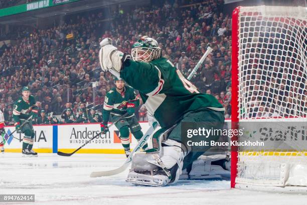 Devan Dubnyk of the Minnesota Wild makes a save against the Calgary Flames during the game at the Xcel Energy Center on December 12, 2017 in St....