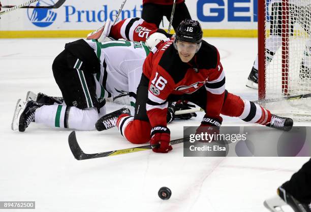 Steven Santini of the New Jersey Devils knocks the shot away as Martin Hanzal of the Dallas Stars falls in the third period on December 15, 2017 at...