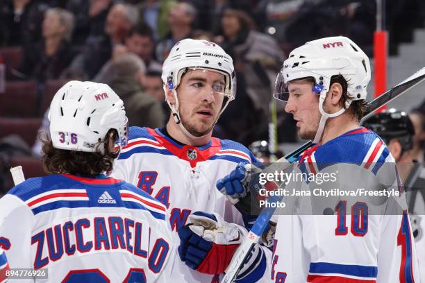 Teammates Mats Zuccarello, Ryan McDonagh and J.T. Miller of the New York Rangers chat during a game against the Ottawa Senators at Canadian Tire...