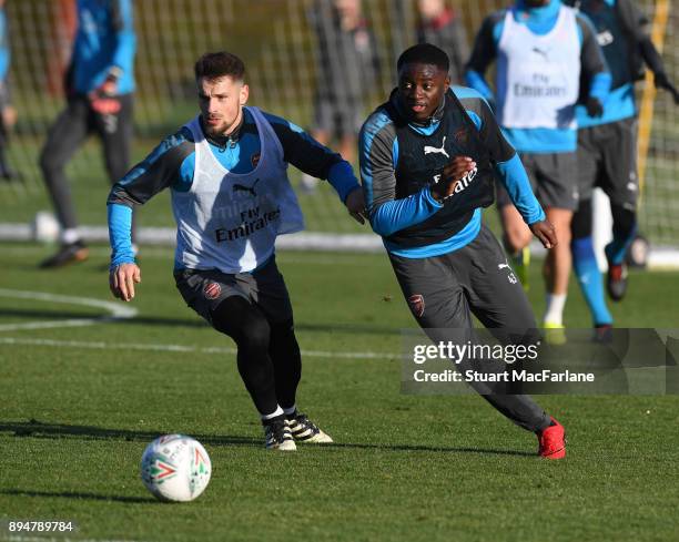 Mathieu Debuchy and Josh Dasilva of Arsenal during a training session at London Colney on December 18, 2017 in St Albans, England.