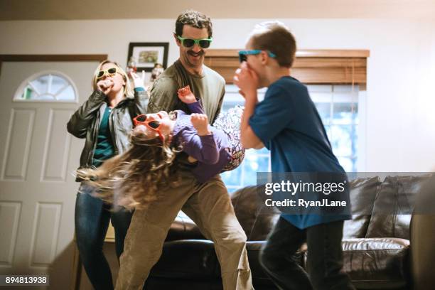 family dancing and singing in living room - parenting funny stock pictures, royalty-free photos & images