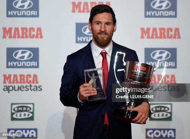 Barcelona's Argentinian forward Lionel Messi poses after receiving the Alfredo Diestefano award and the 'Pichichi' award for the 2016-17 leading...
