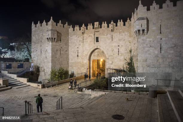 Visitors pass through the Damascus Gate entrance to the Old City at night in Jerusalem, Israel, on Wednesday, Dec. 13, 2017. The United Nations...