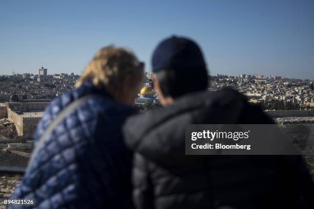 Tourists look out towards the Dome of The Rock on the Temple Mount from Mount of Olives in East Jerusalem, Israel, on Saturday, Dec. 16, 2017. The...