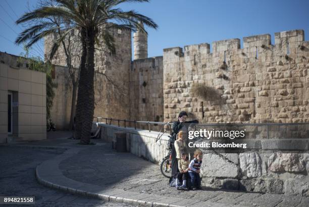 Family stands by the Jaffa Gate entrance to the Old City in Jerusalem, Israel, on Sunday, Dec. 17, 2017. The United Nations Security Council is...