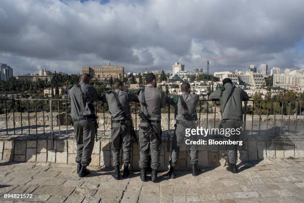 Armed members of the Israeli Defense Force look out over the Western side of the city from the Old City ramparts in Jerusalem, Israel, on Thursday,...