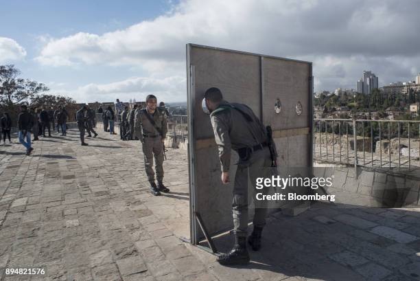 Armed members of the Israeli Defense Force take a break on the ramparts in the Old City in Jerusalem, Israel, on Thursday, Dec. 14, 2017. The United...