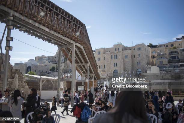 Tourists and locals pass a walkway to Temple Mount running through the Western Wall in Jerusalem, Israel, on Sunday, Dec. 17, 2017. The United...