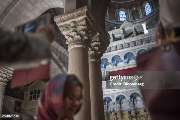 Tourists visit the Church of the Holy Sepulchre in the Christian quarter of the Old City in Jerusalem, Israel, on Sunday, Dec. 17, 2017. The United...