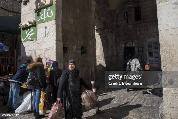 Muslim woman stands by the entrance of Lions Gate in the Muslim quarter of the Old City in Jerusalem, Israel, on Saturday, Dec. 16, 2017. The United...