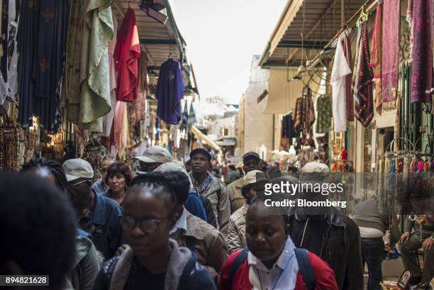 Tourists and locals walk through the Arab souq in the Christian quarter of the Old City in Jerusalem, Israel, on Saturday, Dec. 16, 2017. The United...
