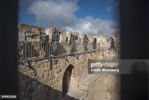 Armed members of the Israeli Defense Force walk along the ramparts in the Old City in Jerusalem, Israel, on Thursday, Dec. 14, 2017. The United...