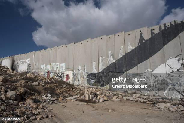 Painted graffiti murals sit on the Israeli West Bank security barrier wall in the Aida refugee camp in Bethlehem, Israel, on Friday, Dec.. 15, 2017....