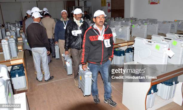Election officials carry electronic voting machines as they arrive to count votes on December 18, 2017 in Dharamsala, India. In Himachal Pradesh...