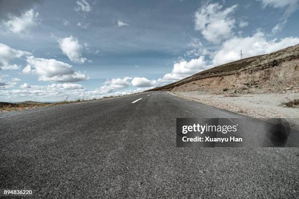 shot of a long open road stretching out far away into the distance - country road stock pictures, royalty-free photos & images