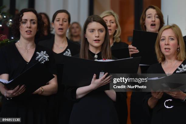 Members of the department's staff choir perfom during an annual lunchtime recital of Christmas Carols at Government Buildings. On Monday, 18 December...