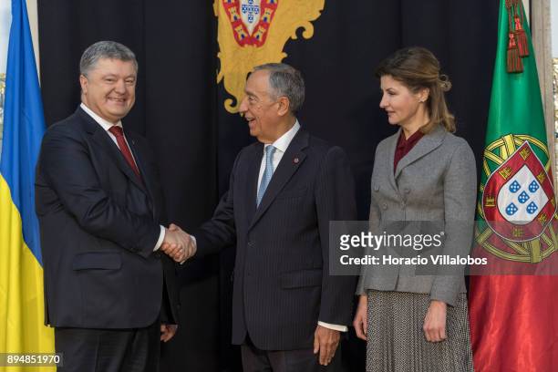 Portuguese President Marcelo Rebelo de Sousa shakes hands with the President of Ukraine Petro Poroshenko while First Lady Maryna Poroshenko looks at...
