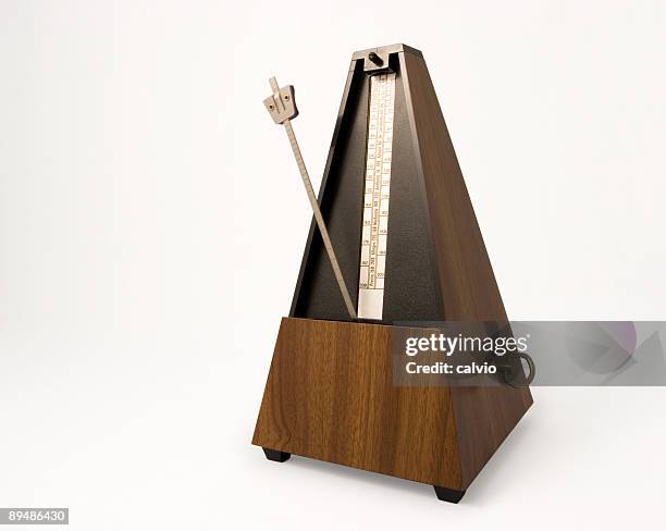 a metronome on a white background  - metronome stock pictures, royalty-free photos & images