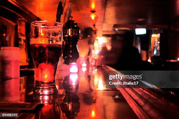 pint glass on bar top - new york city dive-bar - new york dive bar stock pictures, royalty-free photos & images