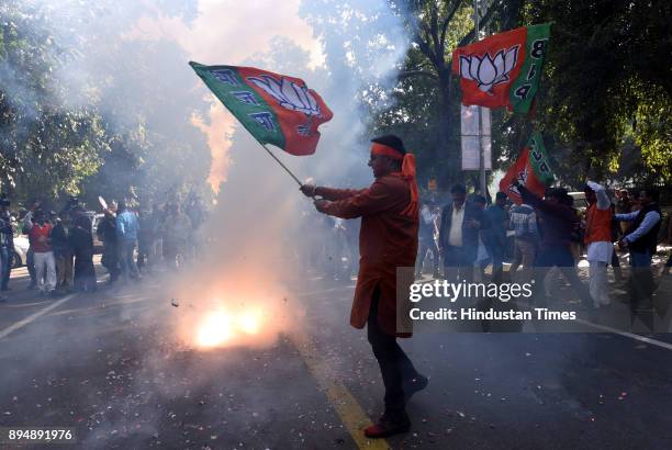 Worker and supporters celebrate after winning Gujarat and Himachal Pradesh Election 2017 at BJP HQ on December 18, 2017 in New Delhi, India. The...