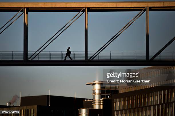 Business man walks over a brigde on December 18, 2017 in Berlin, Germany.