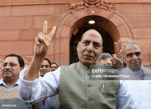 Home Minister Rajnath Singh shows victory sign at Parliament House on December 18, 2017 in New Delhi, India. BJP is likely to win both Gujarat and...