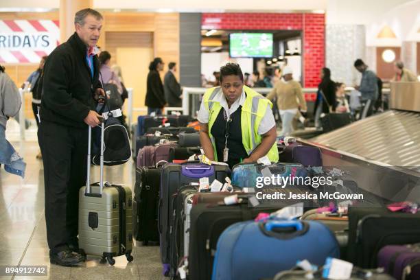 David Walker of Tifton, Ga searches for his luggage at Hartsfield-Jackson Atlanta International Airport on December 18, 2017 in Atlanta, Georgia....