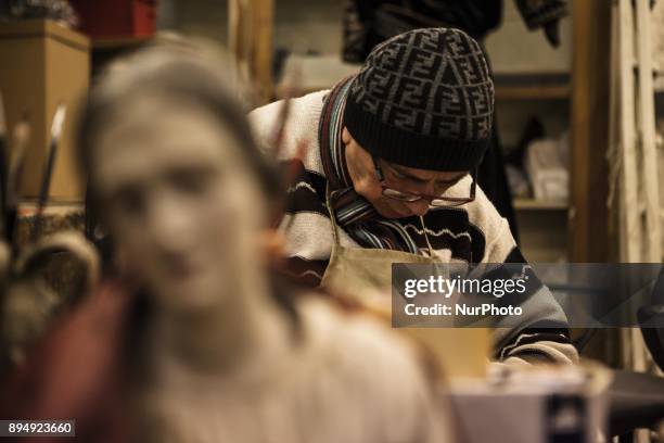 Giuseppe works on a figurine Nativity in his shop Gesarini is seen in 'Via San Gregorio Armeno' in Naples, Italy on December 18, 2017. Various...