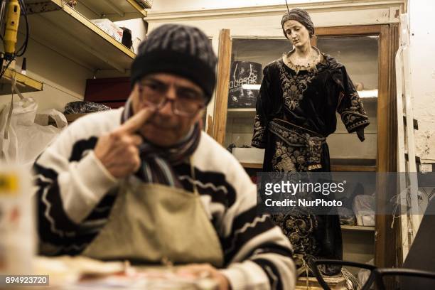 Giuseppe works on a figurine Nativity in his shop Gesarini is seen in 'Via San Gregorio Armeno' in Naples, Italy on December 18, 2017. Various...