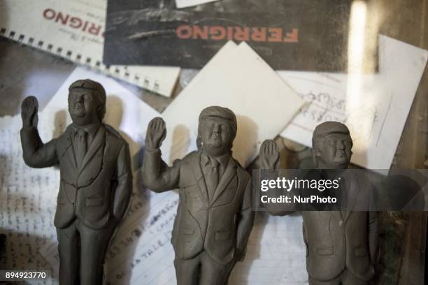 Giuseppina Erzingher works on a figurine Donald Trump in shop Ferrigno in 'Via San Gregorio Armeno' in Naples, Italy on December 18, 2017. Various...