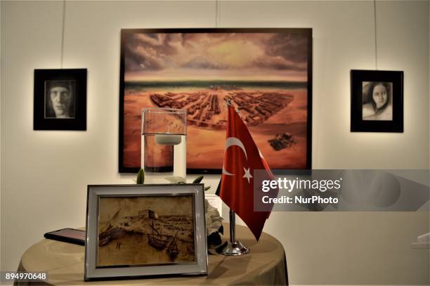 An artwork and a Turkish flag are placed on a table in front of paintings during the opening of the 'Human Creation' Art Exhibition in Ankara, Turkey...