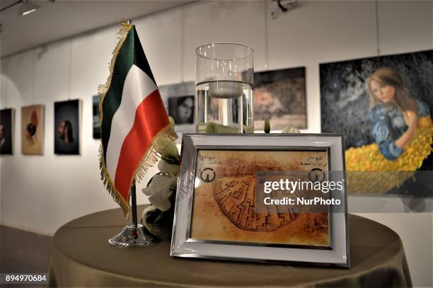 Kuwaiti flag and an artwork are placed on a table in front of paintings during the opening of the 'Human Creation' Art Exhibition in Ankara, Turkey...