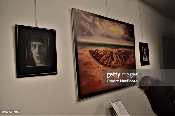 Woman looks at the explanation of a painting during the opening of the 'Human Creation' Art Exhibition in Ankara, Turkey on December 18, 2017. The...