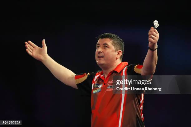 Mensur Suljovic of Austria celebrates after winning his first round match against Kevin Painter of England on day five of the 2018 William Hill PDC...