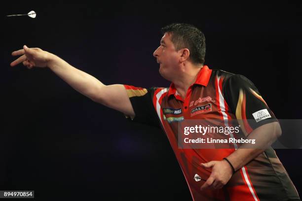 Mensur Suljovic of Austria in action during his first round match against Kevin Painter of England on day five of the 2018 William Hill PDC World...