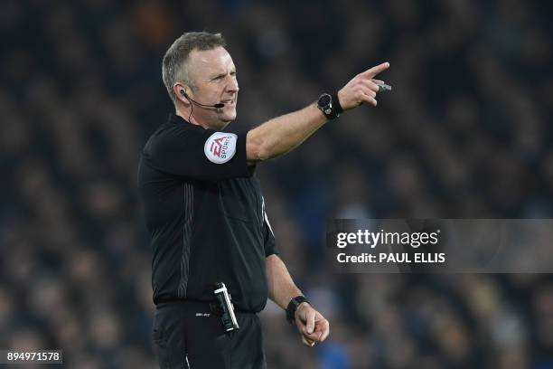 Referee Jonathan Moss gestures during the English Premier League football match between Everton and Swansea City at Goodison Park in Liverpool, north...
