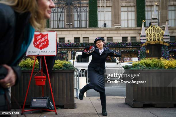 Member of the Salvation Army sings and dances along Fifth Avenue in Midtown Manhattan, December 18, 2017 in New York City. The city is decked out in...