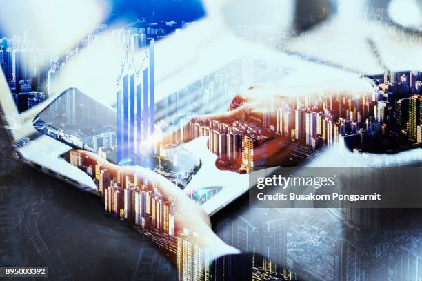 double exposure businessman hand working on smartphone with chart finance and technology - banker doppelbelichtung stock-fotos und bilder